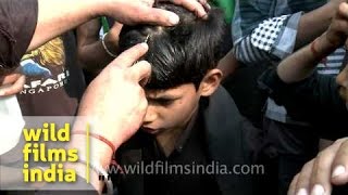 Young Shiite Muslim boy cries as an elder makes a cut on his forehead during Muharram [upl. by Ettedanreb]